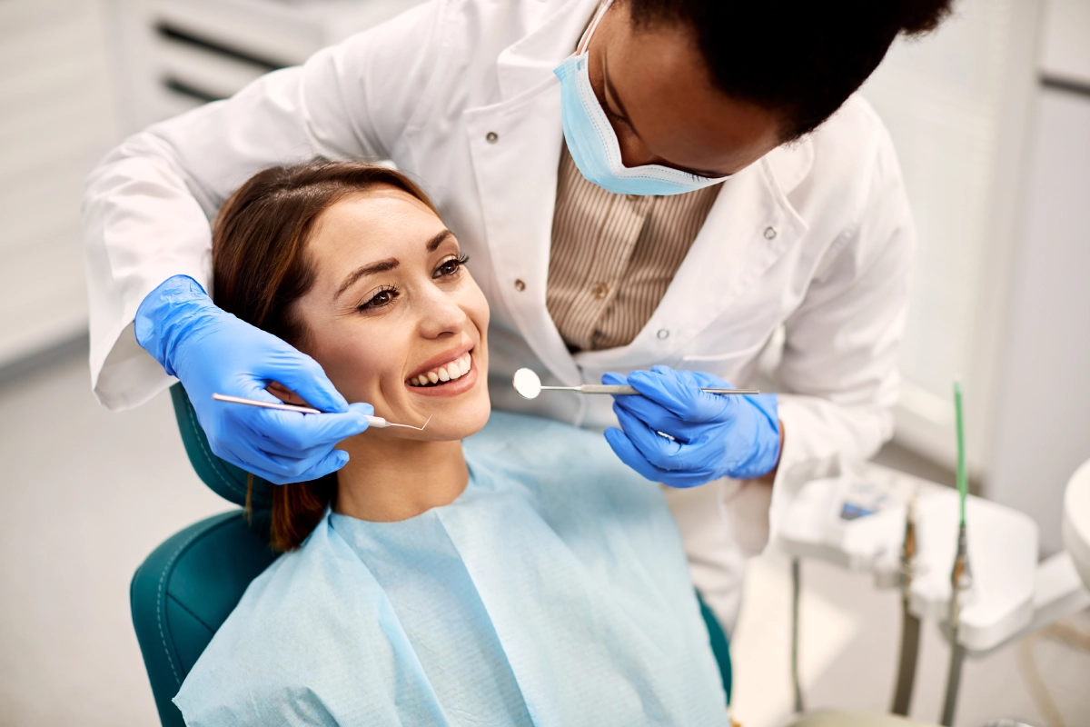 Dentist examining a smiling patient.