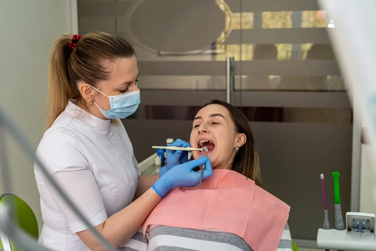 Dentist examining patient in dental office.