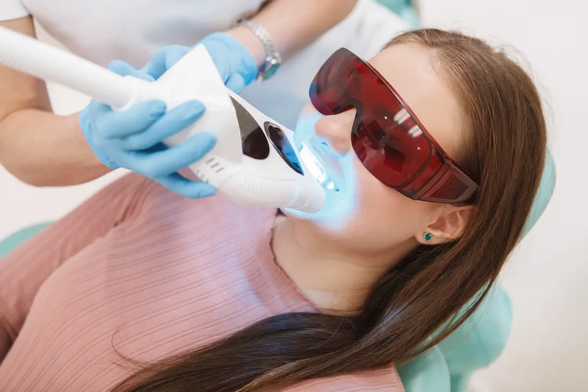 Woman receiving teeth whitening treatment.