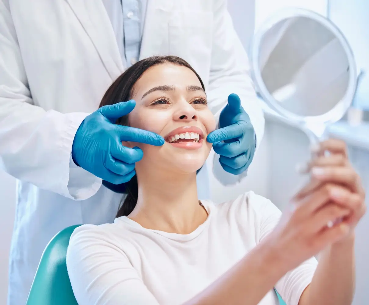 Dentist examining woman's smile with mirror.