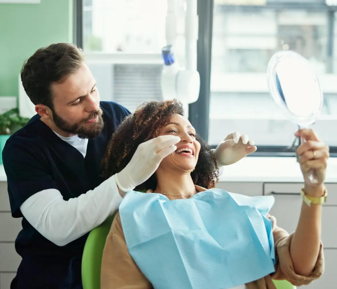 Dentist showing patient their smile in mirror.