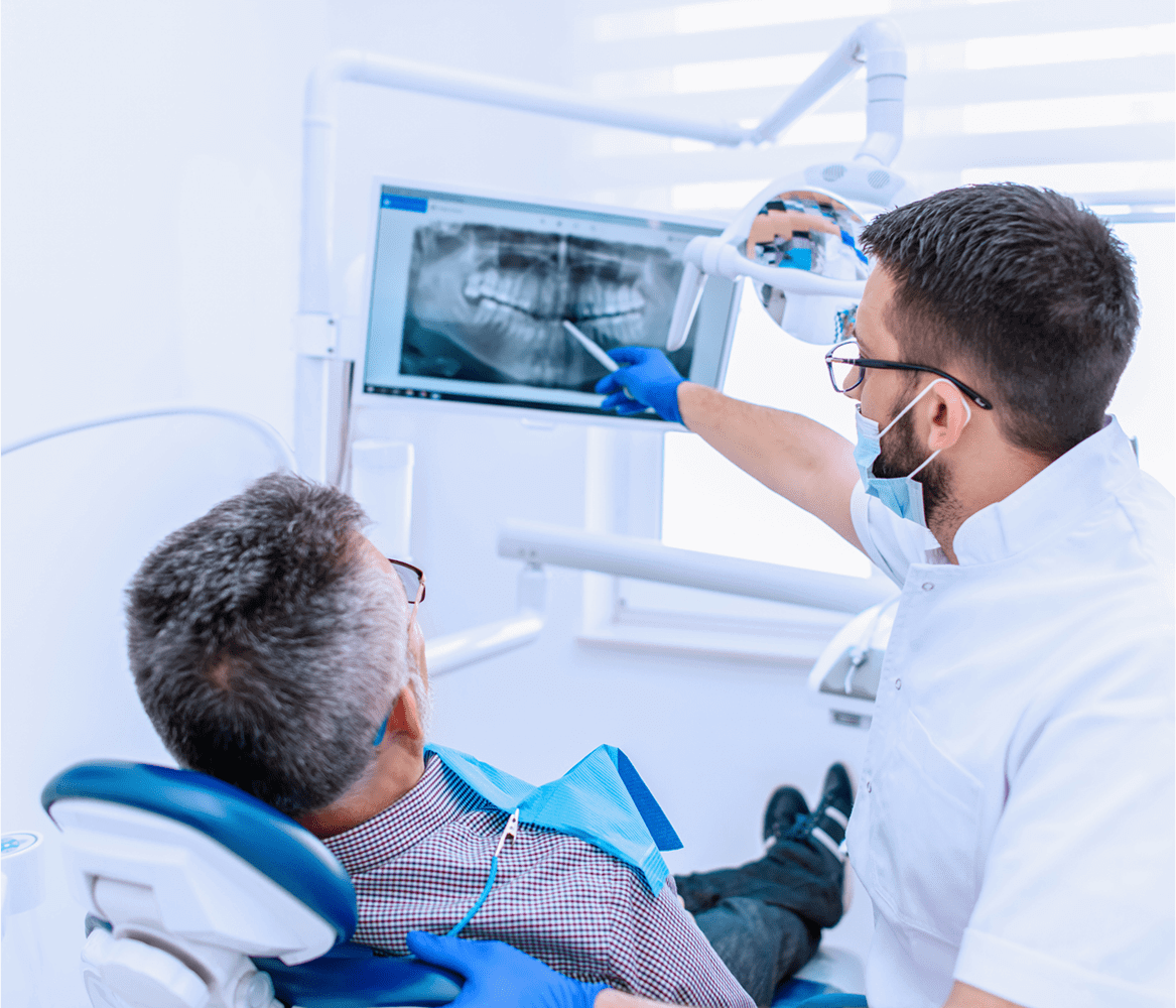 Dentist explaining dental X-ray to patient.