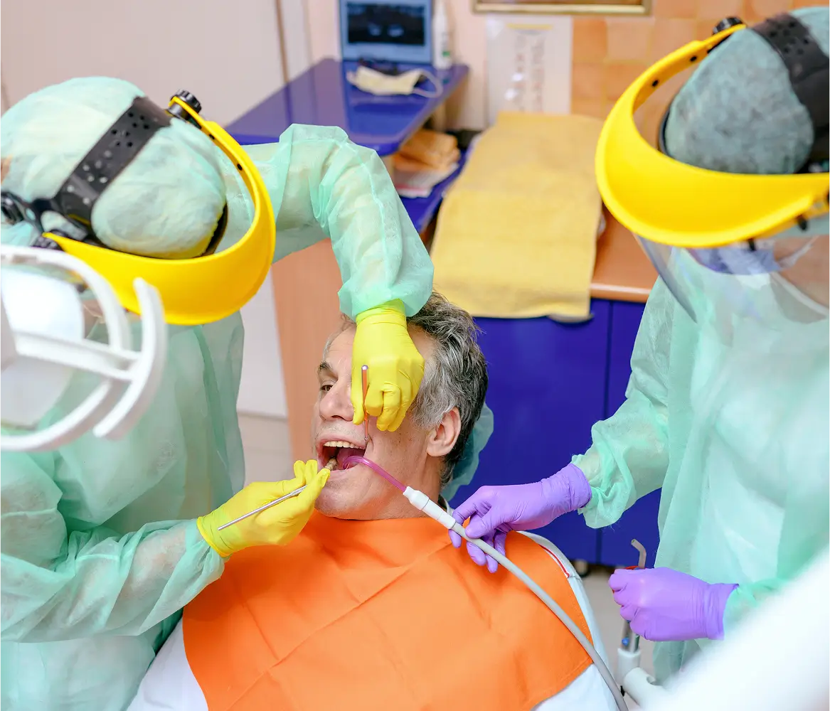 A child receiving dental treatment from two dentists.
