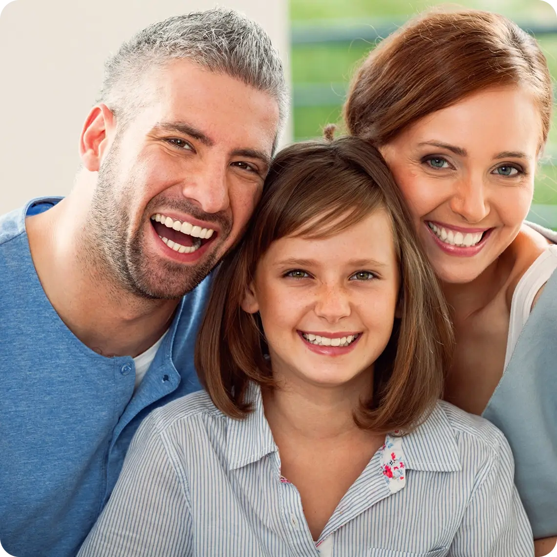 Smiling family posing for a photo together.
